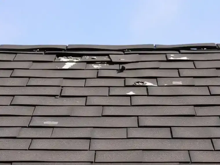 Wind and hail roof damage on residential home after severe storm